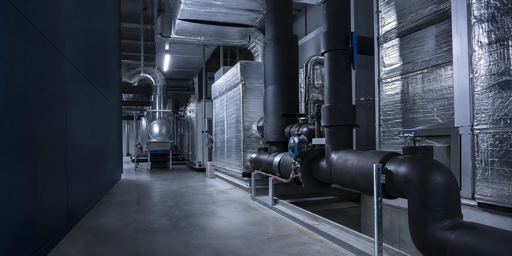 Professionally insulated HVAC pipework and ductwork in a modern plant room